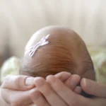 Person holding new born