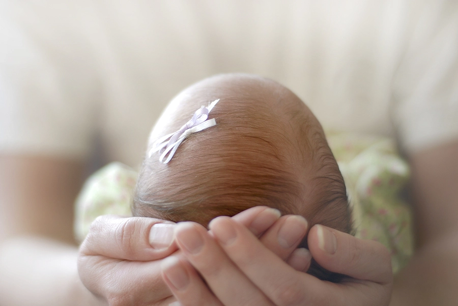 Person holding new born